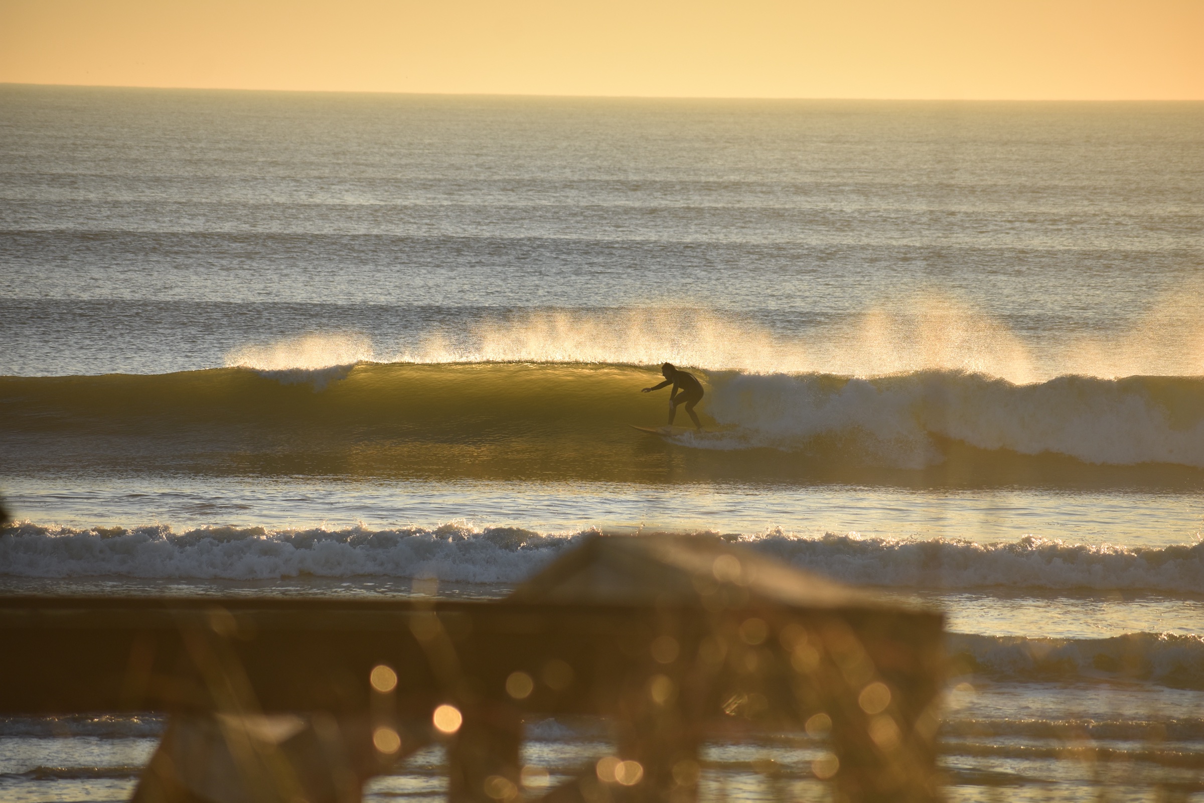 A surfer launching an air off the lip of a wave